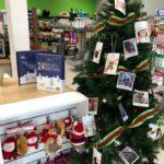A large Christmas tree is covered in tags with the gift wish list for rescue dogs and cats